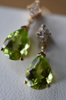 Peridot and Diamond set moving earrings with backings.